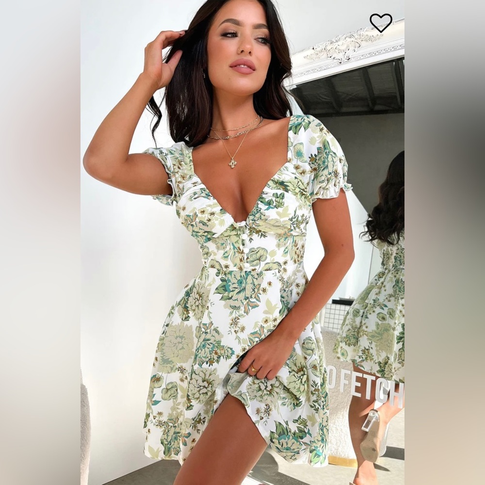 Features a flowy fit, double lined material, and short puffy sleeves.